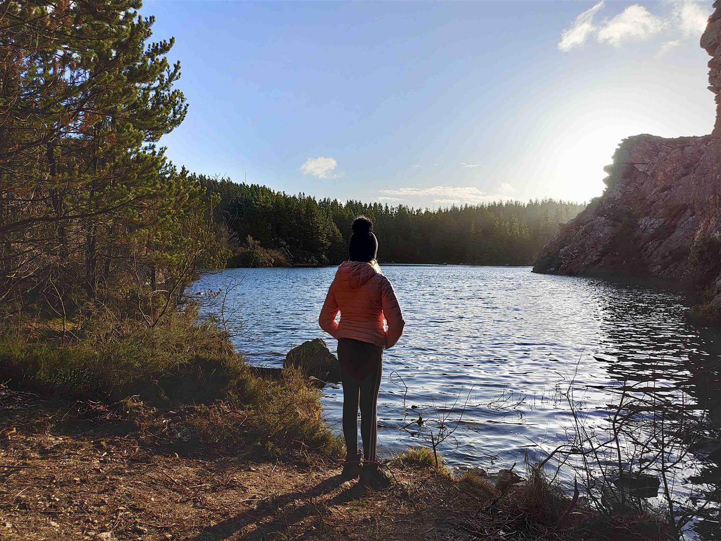 A person standing at a lake 