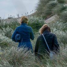 image showing 2 ladies walking up a sand dune