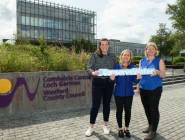 Wexford County Council and Uisce Eireann Staff hold #ConserveWater sign 