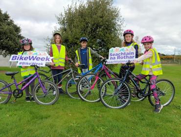 Children with bikes and Bike Week Signs